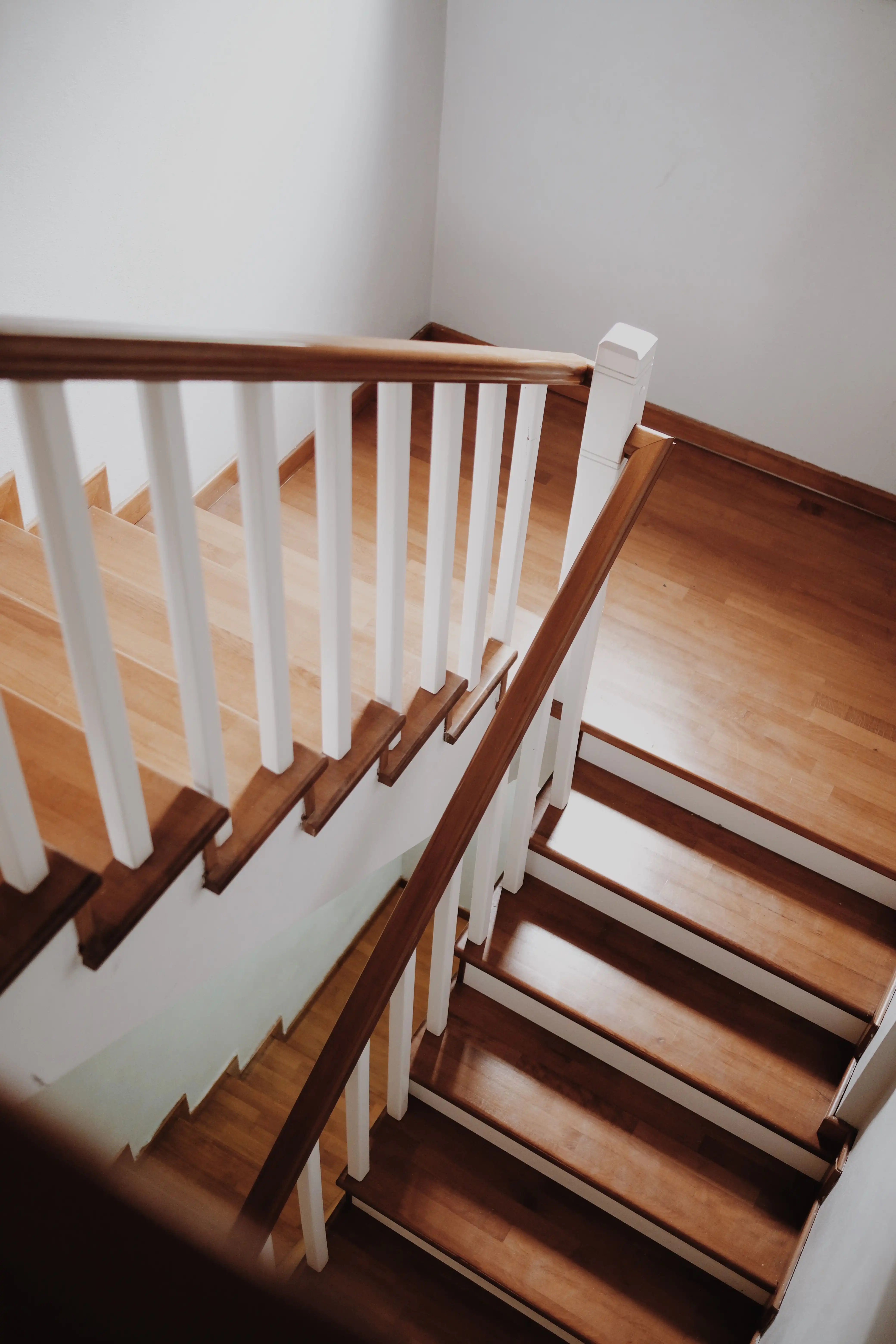 Wide-plank European oak floors and rebuilt staircase in a sunlit living room